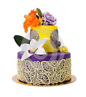 Colorful cake decorated with candy flowers and lace