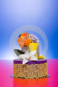 Colorful cake decorated with candy flowers and lace