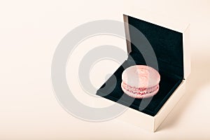 Colorful cake macaroons on a light background. Toned