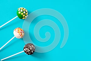 Colorful cake pops on blue background