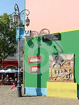 Colorful Caminito Street in La Boca district in Buenos Aires, Argentina. Street lamp and mural