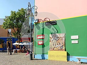 Colorful Caminito Street in La Boca district in Buenos Aires, Argentina. Street lamp and mural