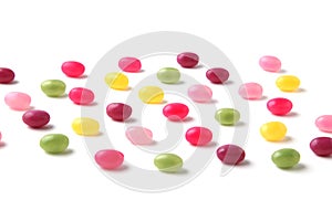 colorful candies jelly beans spread on white background