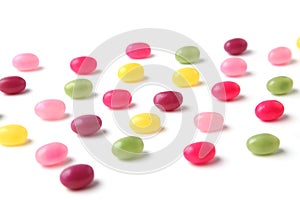 colorful candies jelly beans spread on white background