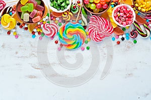 Colorful candies, jelly and marmalade on a white wooden background. Sweets. Top view.