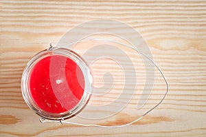 Colorful candle in glass candlesticks on wooden background