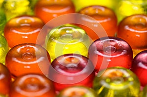 Colorful candy on background with yellow orange and pink sweetmeats candies. Dolce vita. Closeup