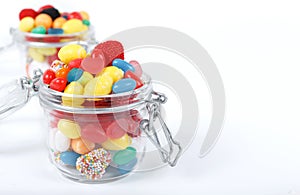 Colorful candy and gum in the glass jar