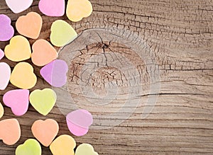 Colorful candy hearts on wooden background