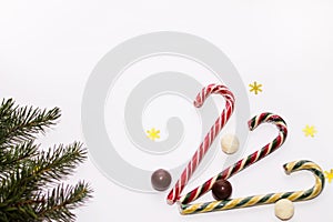 Colorful candy lollipops, chocolate on white background, fir branch, new year, Christmas