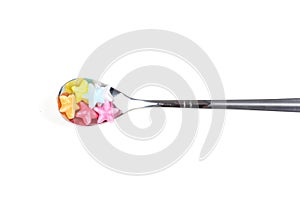 Colorful candy with metal spoon