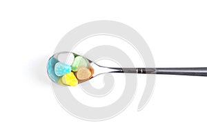 Colorful candy with metal spoon