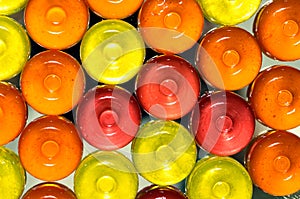 Colorful candy onbackground with  yellow, orange and pink sweetmeats candies. Dolce vita