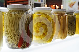 Colorful canned vegetables in glass pot. Food, preser