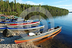 Colorful canoes a lake,Polar Karelia, Russia photo