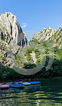Colorful Canoes in Matka Canyon, Macedonia with no person. Kayaks in a pier and sunset in the mountains and lake
