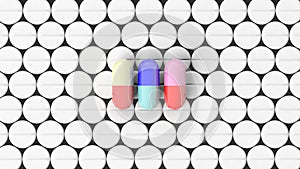 Colorful caplets on top of white round pills