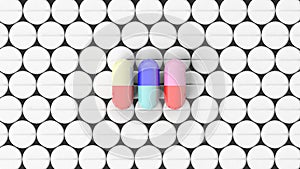 Colorful caplets on top of white round pills photo