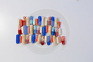 Colorful capsule pills in blister pack isolated on white background with copy space. Antibiotic drug resistance