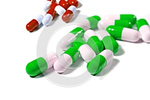 Colorful capsule pills on white background