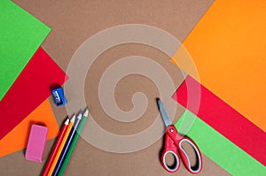 Colorful cardboard, pencils and red scissors