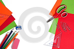 Colorful cardboard, pencils, red scissors and paper clips