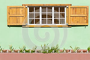 Colorful Caribbean Window and Shutters in a Green Wall II.