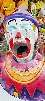 Colorful carnival clown with a large open mouth