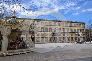 Colorful carousel in front of the Palazzo Ducale on Piazza Napoleone in historic center of Lucca, Italy