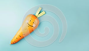 Colorful carrot is shown that looks like its laughing and very happy with its smiley face