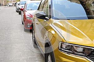 Colorful cars parked on city street, closeup