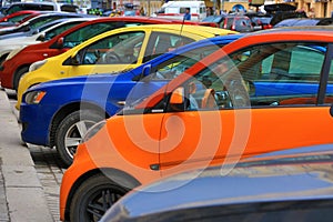 Colorful cars parked on the street, Yellow, blue, red, orange automobiles