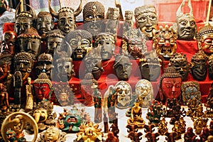 Colorful carved masks are sold, colored masks of different perfumes hang on the wall