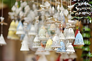 Colorful ceramic bells and other decorations sold on Christmas market in Riga photo