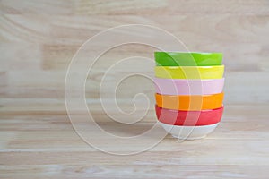 Colorful Ceramic Bowls Stacked On Each Other on Wood Background