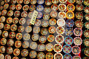 Colorful ceramic plates for sale in Turkey. Decorated tableware in the tourist store. souvenir. Top view