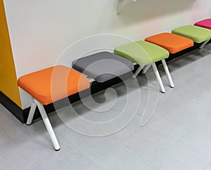 Colorful chairs with fabric cushion within rest area