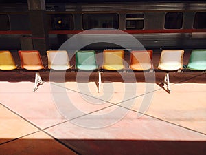 The colorful chairs are on the platform