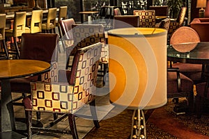 Colorful chairs, tables and lamps in hotel sitting lounge area