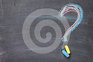 Colorful chalk question mark on blackboard background