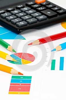 Colorful charts with pencils and calculator