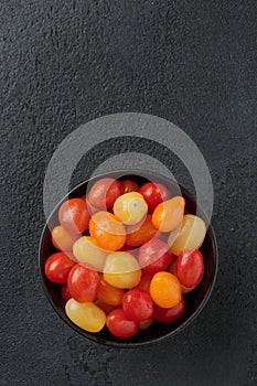 Colorful cherry tomatoes in a black bowl