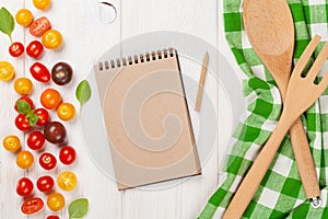 Colorful cherry tomatoes and kitchen utensils