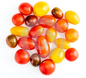 Colorful cherry tomatoes red, garnet and yellow, fresh and raw. With water drops Isolated on white background