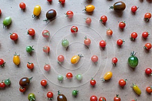 Colorful cherry tomatoes are scattered on the table, upper view. Still life of cherry tomatoes for publication, poster