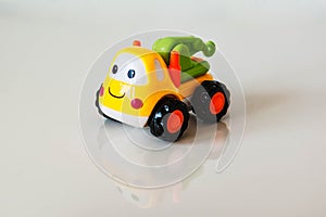 Colorful, children plastic toy, toy truck tractor with a smile a