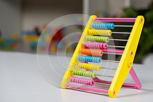 Colorful children's abacus on the table. Mathematics, arithmetic for preschool and school children, learning to