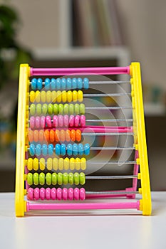 Colorful children's abacus on the table. Mathematics, arithmetic for preschool and school children, learning to