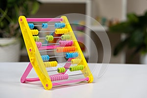 Colorful children's abacus on the table. Mathematics, arithmetic for preschool and school children, learning to