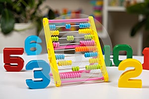 Colorful children's abacus on the table. Mathematics, arithmetic for preschool and school children, learning to